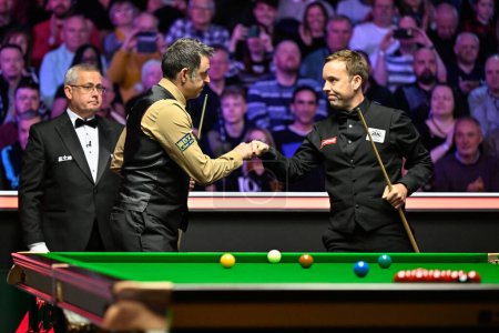 Photo for The two player Ronnie O'Sullivan (left) and Ali Carter (right) bump fists ahead of the start of the match during the Johnstones Paint Tour Championship at Manchester Central, Manchester, United Kingdom, 3rd April 2024 - Royalty Free Image