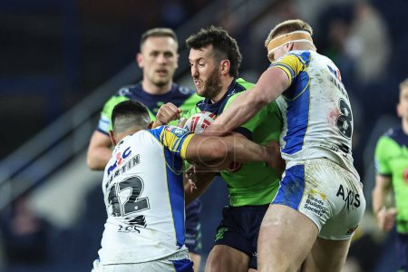 Photo for Stefan Ratchford of Warrington Wolves is tackled by Rhyse Martin of Leeds Rhinos and Mikolaj Oledzki of Leeds Rhinos during the Betfred Super League Round 7 match Leeds Rhinos vs Warrington Wolves at Headingley Stadium, Leeds, United Kingdom, 5th Apr - Royalty Free Image