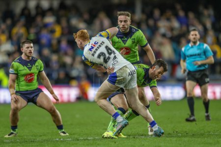 Photo for Luis Roberts of Leeds Rhinos is tackled by Stefan Ratchford of Warrington Wolves during the Betfred Super League Round 7 match Leeds Rhinos vs Warrington Wolves at Headingley Stadium, Leeds, United Kingdom, 5th April 202 - Royalty Free Image