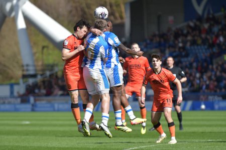 Photo for Ben Jackson of Huddersfield Town and Dan McNamara of Millwall challenge for a header during the Sky Bet Championship match Huddersfield Town vs Millwall at John Smith's Stadium, Huddersfield, United Kingdom, 6th April 2024 - Royalty Free Image