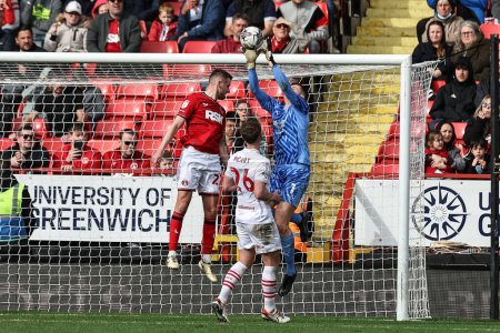 Photo for Liam Roberts of Barnsley jumps up to win the high ball during the Sky Bet League 1 match Charlton Athletic vs Barnsley at The Valley, London, United Kingdom, 6th April 202 - Royalty Free Image