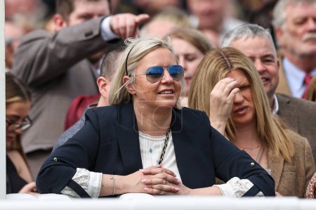 Photo for A racegoer watches the first race during the Randox Grand National 2024 Opening Day at Aintree Racecourse, Liverpool, United Kingdom, 11th April 202 - Royalty Free Image