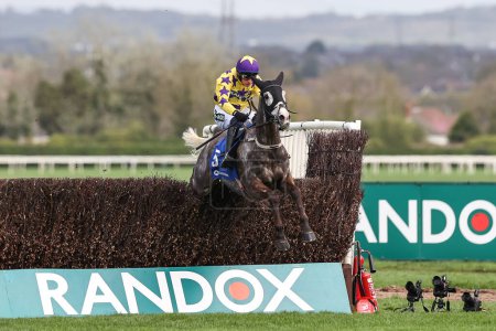 Photo for Il Etait Temps ridden by Paul Townend jumps the last fence on the way to winning the 1.45pm The Close Brothers Manifesto Novices Steeple Chase (Class 1) during the Randox Grand National 2024 Opening Day at Aintree Racecourse, Liverpool, UK - Royalty Free Image