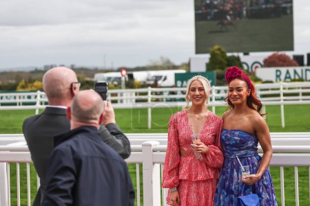 Photo for Racegoers having a photo near the finish line during the The Randox Grand National 2024 Ladies Day at Aintree Racecourse, Liverpool, United Kingdom, 12th April 202 - Royalty Free Image
