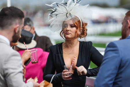 Photo for Racegoers having drinks during the The Randox Grand National 2024 Ladies Day at Aintree Racecourse, Liverpool, United Kingdom, 12th April 202 - Royalty Free Image