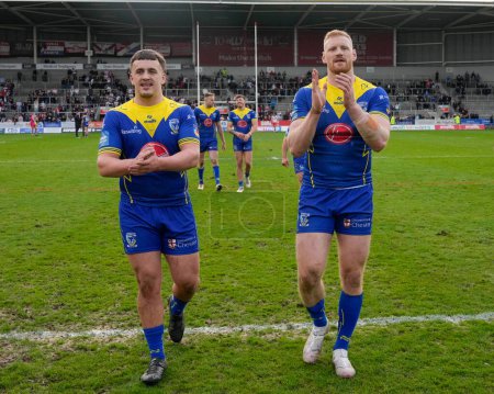 Photo for Max Wood and Joe Bullock of Warrington Wolves salute the fans after the Betfred Challenge Cup Quarter Final match St Helens vs Warrington Wolves at Totally Wicked Stadium, St Helens, United Kingdom, 14th April 202 - Royalty Free Image