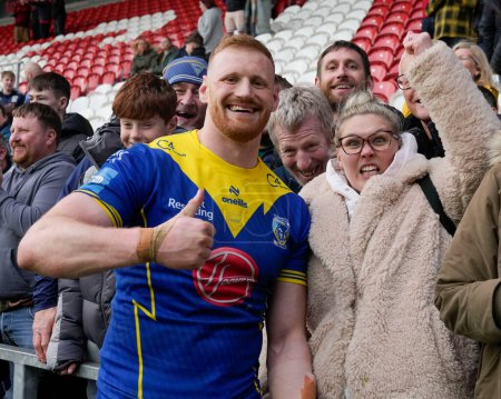 Photo for Joe Bullock of Warrington Wolves with the fans after the Betfred Challenge Cup Quarter Final match St Helens vs Warrington Wolves at Totally Wicked Stadium, St Helens, United Kingdom, 14th April 202 - Royalty Free Image