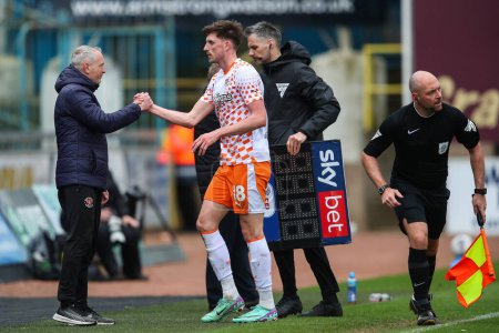Photo for Neil Critchley manager of Blackpool and Jake Beesley of Blackpool embrace during the Sky Bet League 1 match Carlisle United vs Blackpool at Brunton Park, Carlisle, United Kingdom, 13th April 202 - Royalty Free Image