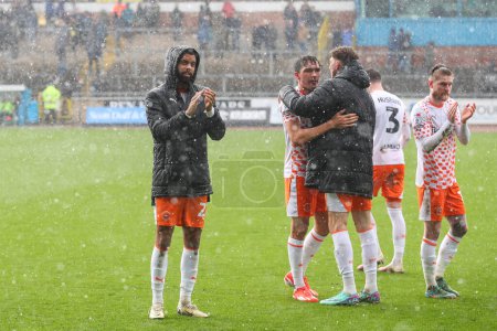 Photo for CJ Hamilton of Blackpool applauds the travelling fans after the Sky Bet League 1 match Carlisle United vs Blackpool at Brunton Park, Carlisle, United Kingdom, 13th April 202 - Royalty Free Image