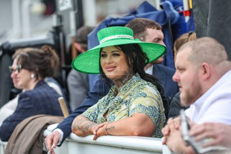 Photo for Racegoers enjoy the atmosphere during the The Randox Grand National 2024 Ladies Day at Aintree Racecourse, Liverpool, United Kingdom, 12th April 202 - Royalty Free Image