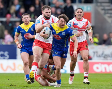 Photo for Matty Ashton of Warrington Wolves makes a break past Alex Walmsley of St. Helens during the Betfred Challenge Cup Quarter Final match St Helens vs Warrington Wolves at Totally Wicked Stadium, St Helens, United Kingdom, 14th April 202 - Royalty Free Image