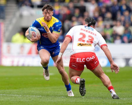 Photo for Matty Ashton of Warrington Wolves runs at Konrad Hurrell of St. Helens during the Betfred Challenge Cup Quarter Final match St Helens vs Warrington Wolves at Totally Wicked Stadium, St Helens, United Kingdom, 14th April 202 - Royalty Free Image