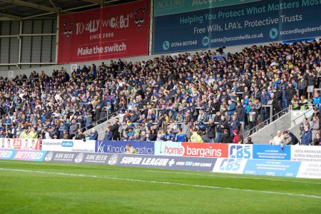 Photo for Wire fans travelled in number for the Betfred Challenge Cup Quarter Final match St Helens vs Warrington Wolves at Totally Wicked Stadium, St Helens, United Kingdom, 14th April 202 - Royalty Free Image