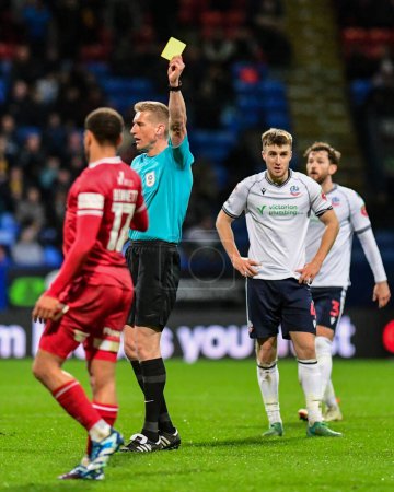 Photo for Referee Scott Oldham gives a yellow card to Elliott Bennett of Shrewsbury Town during the Sky Bet League 1 match Bolton Wanderers vs Shrewsbury Town at Toughsheet Community Stadium, Bolton, United Kingdom, 16th April 202 - Royalty Free Image