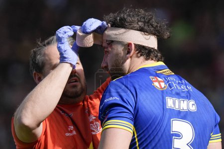 Photo for Toby King of Warrington Wolves receives treatment to a head wound during the Betfred Super League Round 8 match Warrington Wolves vs Leigh Leopards at Halliwell Jones Stadium, Warrington, United Kingdom, 20th April 202 - Royalty Free Image