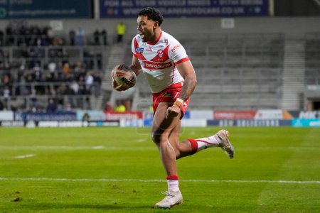 Photo for Waqa Blake of St. Helens runs to with the ball during the Betfred Super League  Round 8 match St Helens vs Hull FC at Totally Wicked Stadium, St Helens, United Kingdom, 19th April 202 - Royalty Free Image