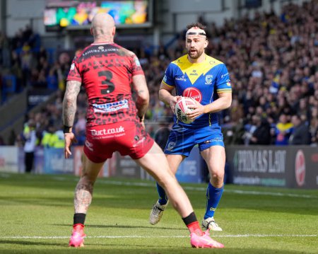 Photo for Toby King of Warrington Wolves runs at Zak Hardaker of Leigh Leopards during the Betfred Super League Round 8 match Warrington Wolves vs Leigh Leopards at Halliwell Jones Stadium, Warrington, United Kingdom, 20th April 202 - Royalty Free Image