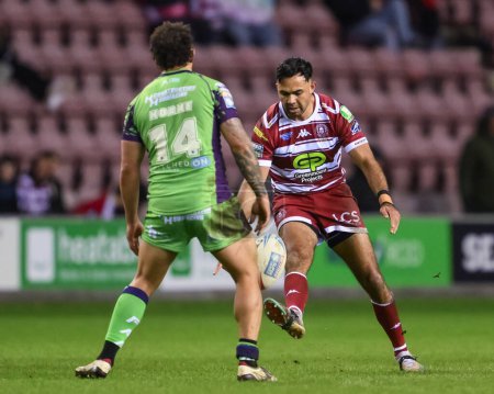 Photo for Bevan French of Wigan Warriors kicks ahead during the Betfred Super League Round 8 match Wigan Warriors vs Castleford Tigers at DW Stadium, Wigan, United Kingdom, 19th April 202 - Royalty Free Image