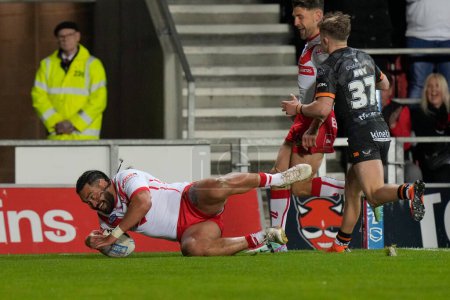 Photo for Konrad Hurrell of St. Helens dives over the line to score a try during the Betfred Super League  Round 8 match St Helens vs Hull FC at Totally Wicked Stadium, St Helens, United Kingdom, 19th April 202 - Royalty Free Image