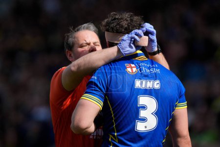 Photo for Toby King of Warrington Wolves has a cut head bandaged during the Betfred Super League Round 8 match Warrington Wolves vs Leigh Leopards at Halliwell Jones Stadium, Warrington, United Kingdom, 20th April 202 - Royalty Free Image