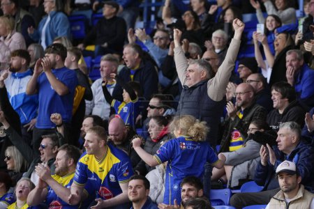 Photo for Warrington Wolves fans celebrate their 16-14 victory after the Betfred Super League Round 8 match Warrington Wolves vs Leigh Leopards at Halliwell Jones Stadium, Warrington, United Kingdom, 20th April 202 - Royalty Free Image