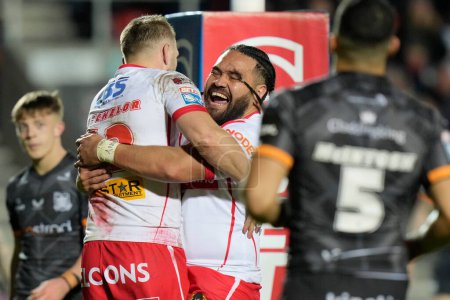 Photo for Konrad Hurrell of St. Helens celebrates with try scorer Joe Batchelor of St. Helens during the Betfred Super League  Round 8 match St Helens vs Hull FC at Totally Wicked Stadium, St Helens, United Kingdom, 19th April 202 - Royalty Free Image