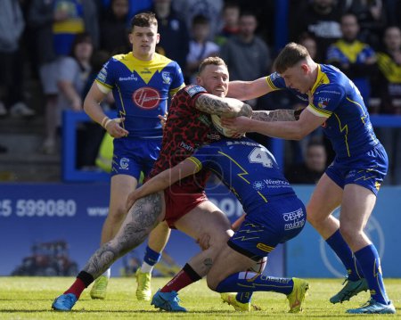 Photo for Stefan Ratchford of Warrington Wolves and Matty Nicholson of Warrington Wolves combine to tackle Josh Charnley of Leigh Leopards during the Betfred Super League Round 8 match Warrington Wolves vs Leigh Leopards at Halliwell Jones Stadium, Warrington, - Royalty Free Image