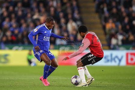 Photo for Abdul Fatawu of Leicester City is tackled by Kyle Walker-Peters of Southampton during the Sky Bet Championship match Leicester City vs Southampton at King Power Stadium, Leicester, United Kingdom, 23rd April 202 - Royalty Free Image