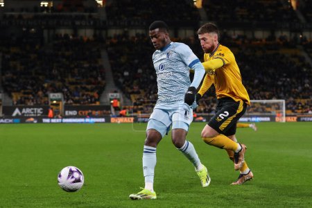 Photo for Dango Ouattara of Bournemouth holds off Matt Doherty of Wolverhampton Wanderers during the Premier League match Wolverhampton Wanderers vs Bournemouth at Molineux, Wolverhampton, United Kingdom, 24th April 202 - Royalty Free Image