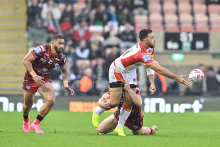 Photo for Matt Ikuvalu of Catalan Dragons passes the ball while being tackled by Lachlan Lam of Leigh Leopards, during the Betfred Super League Round 9 match Leigh Leopards vs Catalans Dragons at Leigh Sports Village, Leigh, United Kingdom, 26th April 202 - Royalty Free Image