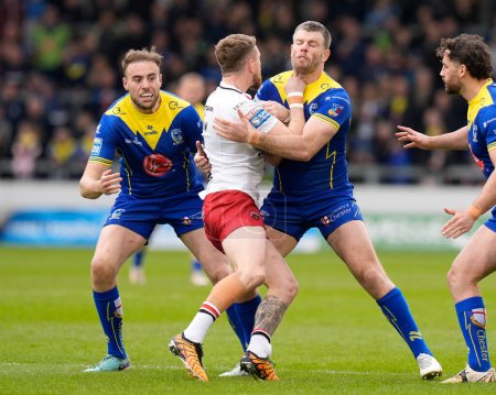 Photo for James Harrison of Warrington Wolves and Lachlan Fitzgibbon of Warrington Wolves combine to tackle Ethan Ryan of Salford Red Devils  during the Betfred Super League Round 9 match Salford Red Devils vs Warrington Wolves at Salford Community Stadium, Ec - Royalty Free Image