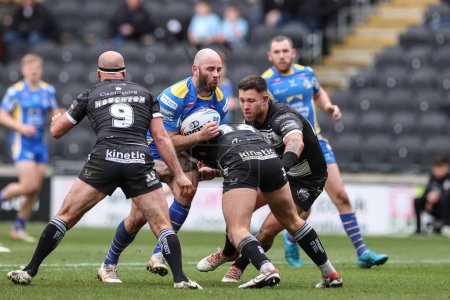 Photo for Matt Frawley of Leeds Rhinos is tackled by Joe Cator Hull FC during the Betfred Super League Round 9 match Hull FC vs Leeds Rhinos at MKM Stadium, Hull, United Kingdom, 28th April 202 - Royalty Free Image