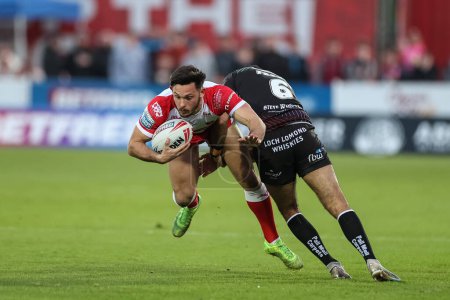 Photo for Niall Evalds of Hull KR is tackled by Bevan French of Wigan Warriors during the Betfred Super League Round 9 match Hull KR vs Wigan Warriors at Sewell Group Craven Park, Kingston upon Hull, United Kingdom, 26th April 202 - Royalty Free Image