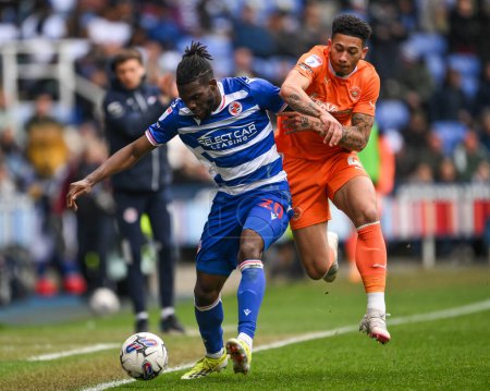 Photo for Jordan Lawrence-Gabriel of Blackpool and Jeriel Dorsett of Reading battle for the ball during the Sky Bet League 1 match Reading vs Blackpool at Select Car Leasing Stadium, Reading, United Kingdom, 27th April 202 - Royalty Free Image