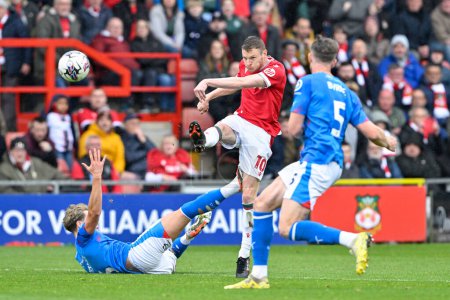 Photo for Paul Mullin of Wrexham strikes the ball at goal, during the Sky Bet League 2 match Wrexham vs Stockport County at SToK Cae Ras, Wrexham, United Kingdom, 27th April 202 - Royalty Free Image