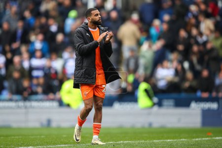 Photo for CJ Hamilton of Blackpool applauds the travelling fans after the Sky Bet League 1 match Reading vs Blackpool at Select Car Leasing Stadium, Reading, United Kingdom, 27th April 202 - Royalty Free Image