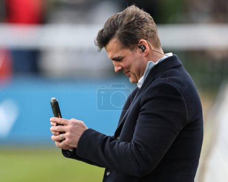 Photo for Brian Carney on his phone during the Betfred Super League Round 9 match Hull KR vs Wigan Warriors at Sewell Group Craven Park, Kingston upon Hull, United Kingdom, 26th April 202 - Royalty Free Image