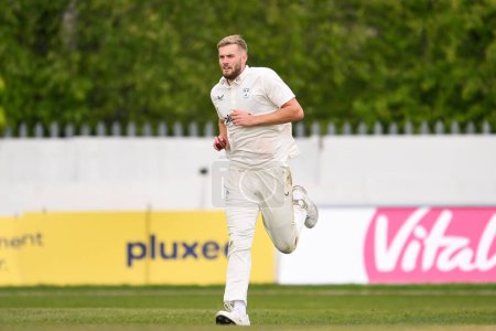 Photo for Adam Finch of Worcestershire runs into bowl during the Vitality County Championship Division 1 match Worcestershire vs Somerset at Kidderminster Cricket Club, Kidderminster, United Kingdom, 26th April 202 - Royalty Free Image