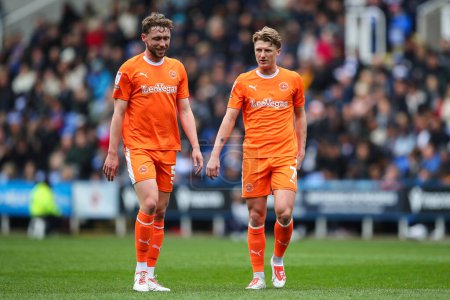 Photo for George Byers of Blackpool talks to Matthew Pennington of Blackpool during the Sky Bet League 1 match Reading vs Blackpool at Select Car Leasing Stadium, Reading, United Kingdom, 27th April 202 - Royalty Free Image