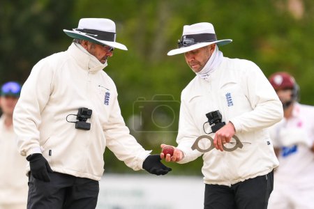 Photo for Umpires Mike Burns and Richard Illingworth check the ball shape during overs during the Vitality County Championship Division 1 match Worcestershire vs Somerset at Kidderminster Cricket Club, Kidderminster, United Kingdom, 26th April 202 - Royalty Free Image