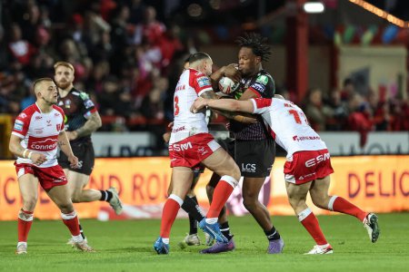 Photo for Junior Nsemba of Wigan Warriors is tackled by Elliot Minchella of Hull KR during the Betfred Super League Round 9 match Hull KR vs Wigan Warriors at Sewell Group Craven Park, Kingston upon Hull, United Kingdom, 26th April 202 - Royalty Free Image