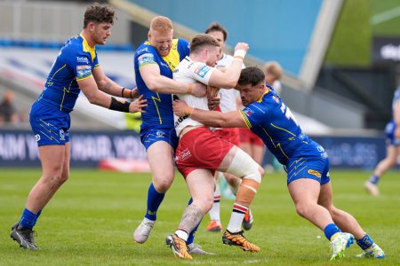 Photo for Joe Bullock of Warrington Wolves and Joe Philbin of Warrington Wolves combine to tackle Ethan Ryan of Salford Red Devils during the Betfred Super League Round 9 match Salford Red Devils vs Warrington Wolves at Salford Community Stadium, Eccles, Unite - Royalty Free Image