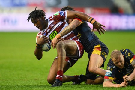 Photo for Junior Nsemba of Wigan Warriors is tackled by Arthur Romano of Catalan Dragons during the Betfred Super League Round 10 match Wigan Warriors vs Catalans Dragons at DW Stadium, Wigan, United Kingdom, 2nd May 2024 - Royalty Free Image