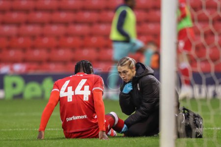 Photo for Devante Cole of Barnsley receives treatment during the Sky Bet League 1 Sky Bet League 1 Promotion Play-offs Semi-final first leg match Barnsley vs Bolton Wanderers at Oakwell, Barnsley, United Kingdom, 3rd May 2024 - Royalty Free Image