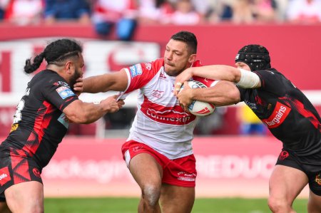 Photo for Ryan Hall of Hull KR is tackled by Konrad Hurrell of St. Helens and Jonny Lomax of St. Helens during the Betfred Super League Round 10 match Hull KR vs St Helens at Sewell Group Craven Park, Kingston upon Hull, United Kingdom, 4th May 2024 - Royalty Free Image