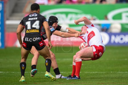 Photo for Jack Broadbent of Hull KR is tackled by Jonny Lomax of St. Helens during the Betfred Super League Round 10 match Hull KR vs St Helens at Sewell Group Craven Park, Kingston upon Hull, United Kingdom, 4th May 2024 - Royalty Free Image