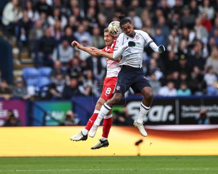 Photo for Herbie Kane of Barnsley and Paris Maghoma of Bolton Wanderers battle for the ball during the Sky Bet League 1 Play-offs Semi-final second leg match Bolton Wanderers vs Barnsley at Toughsheet Community Stadium, Bolton, United Kingdom, 7th May 2024 - Royalty Free Image