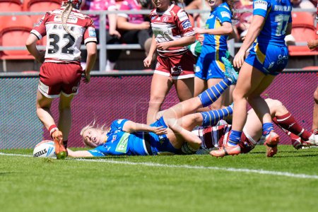 Photo for Keara Bennett of Leeds Rhinos stretches over the line to score a try during the Betfred Women's Challenge Cup Semi-Final match Leeds Rhinos vs Wigan Warriors at Totally Wicked Stadium, St Helens, United Kingdom, 19th May 2024 - Royalty Free Image