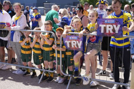 Photo for Young Warrington Wolves fans await their teams arrival before the Betfred Challenge Cup Semi-Final match Huddersfield Giants vs Warrington Wolves at Totally Wicked Stadium, St Helens, United Kingdom, 19th May 2024 - Royalty Free Image