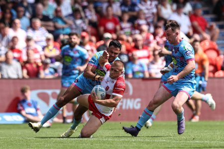 Photo for Mikey Lewis of Hull KR is tackled by Bevan French of Wigan Warriors during the Betfred Challenge Cup Semi-Final Hull KR v Wigan Warriors at Eco-Power Stadium, Doncaster, United Kingdom, 18th May 2024 - Royalty Free Image